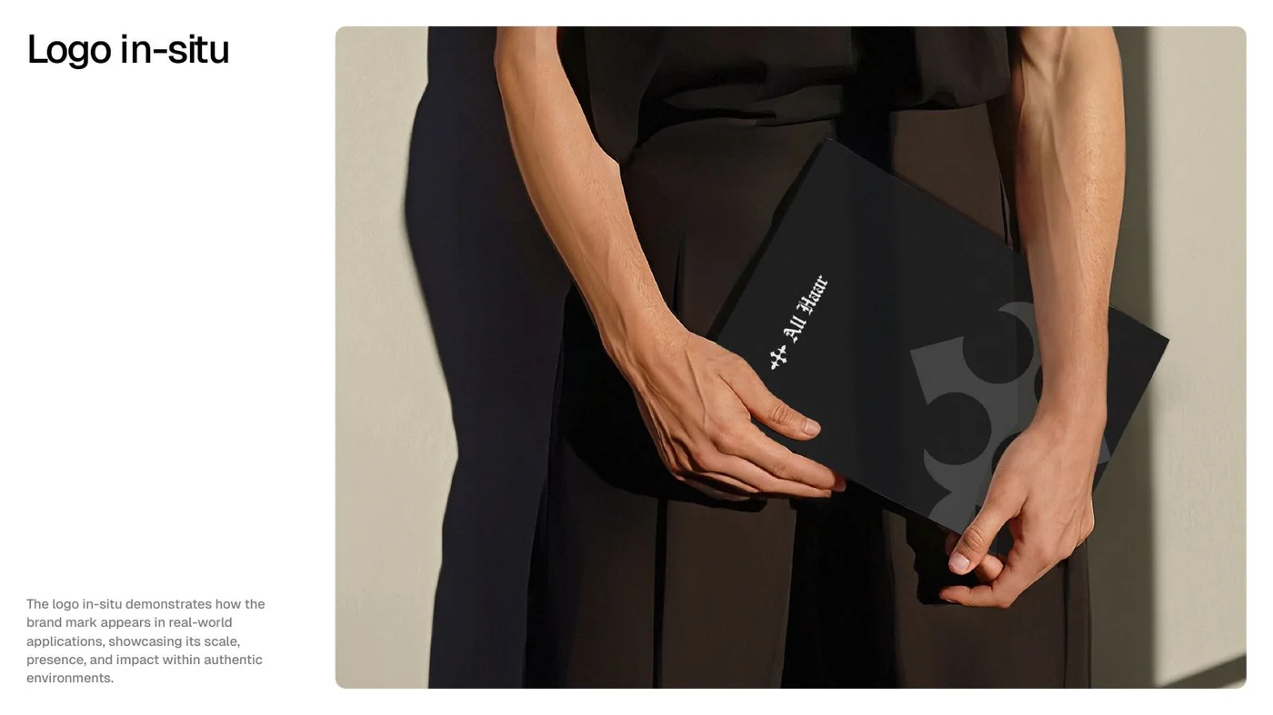 All Haar logo applied in situ on a black presentation folder held by a model